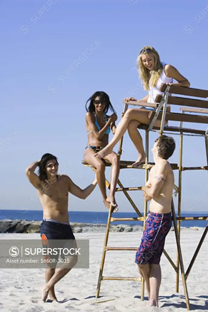 Four young people on the beach