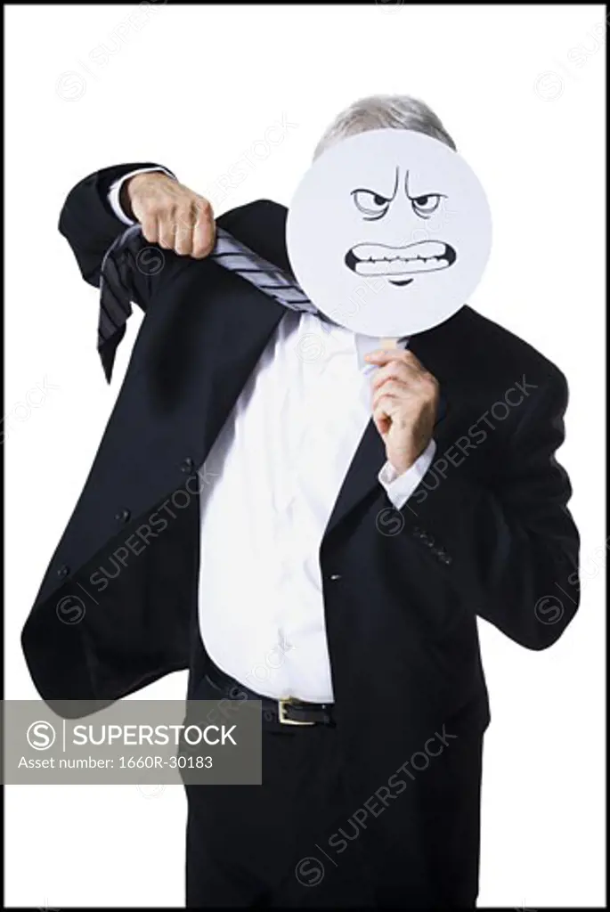Businessman holding a determined face mask