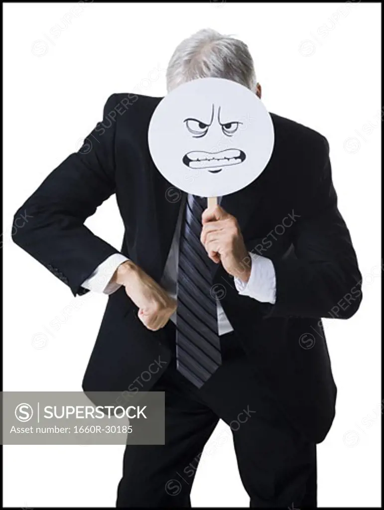 Businessman holding a determined face mask