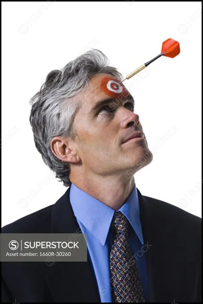 Man with bull's-eye on forehead and dart coming toward him