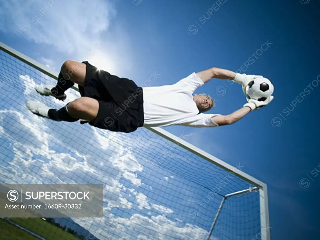 Soccer goalkeeper making diving save