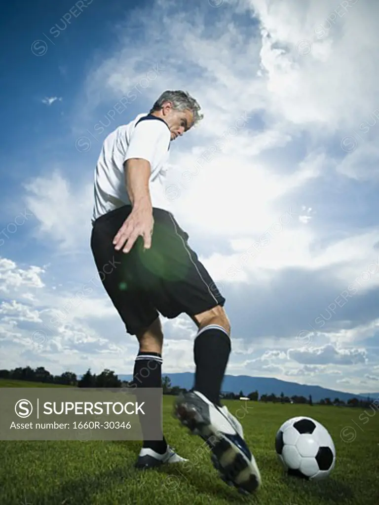 Soccer player kicking ball
