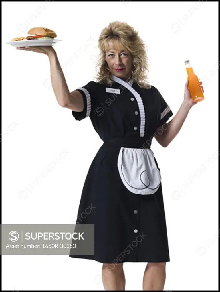 Waitress holding hamburger platter and orange soda