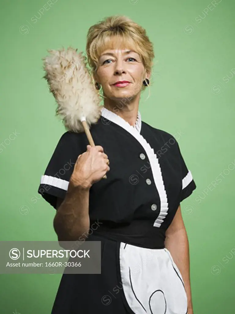 Female housekeeper with feather duster
