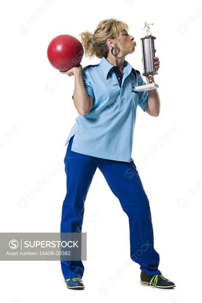Female bowler holding trophy