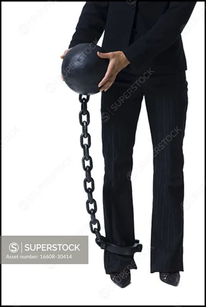 Businesswoman shackled to ball and chain