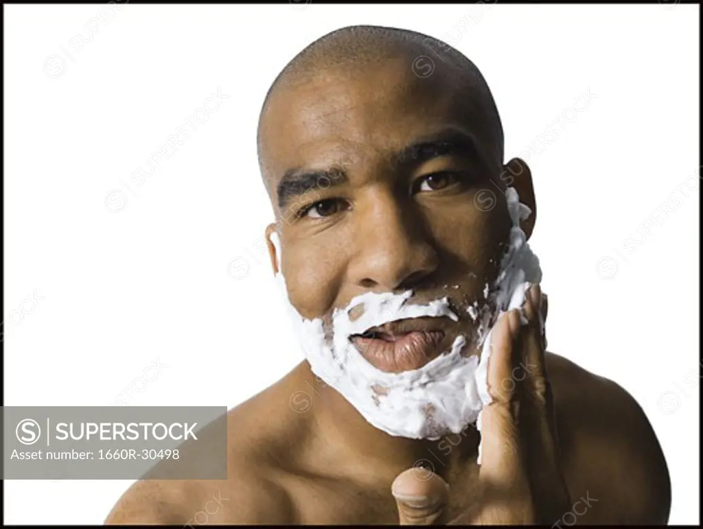 Man with shaving lotion on face