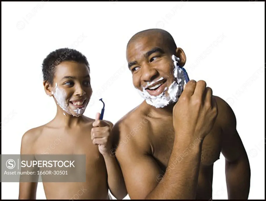 Father and son shaving together