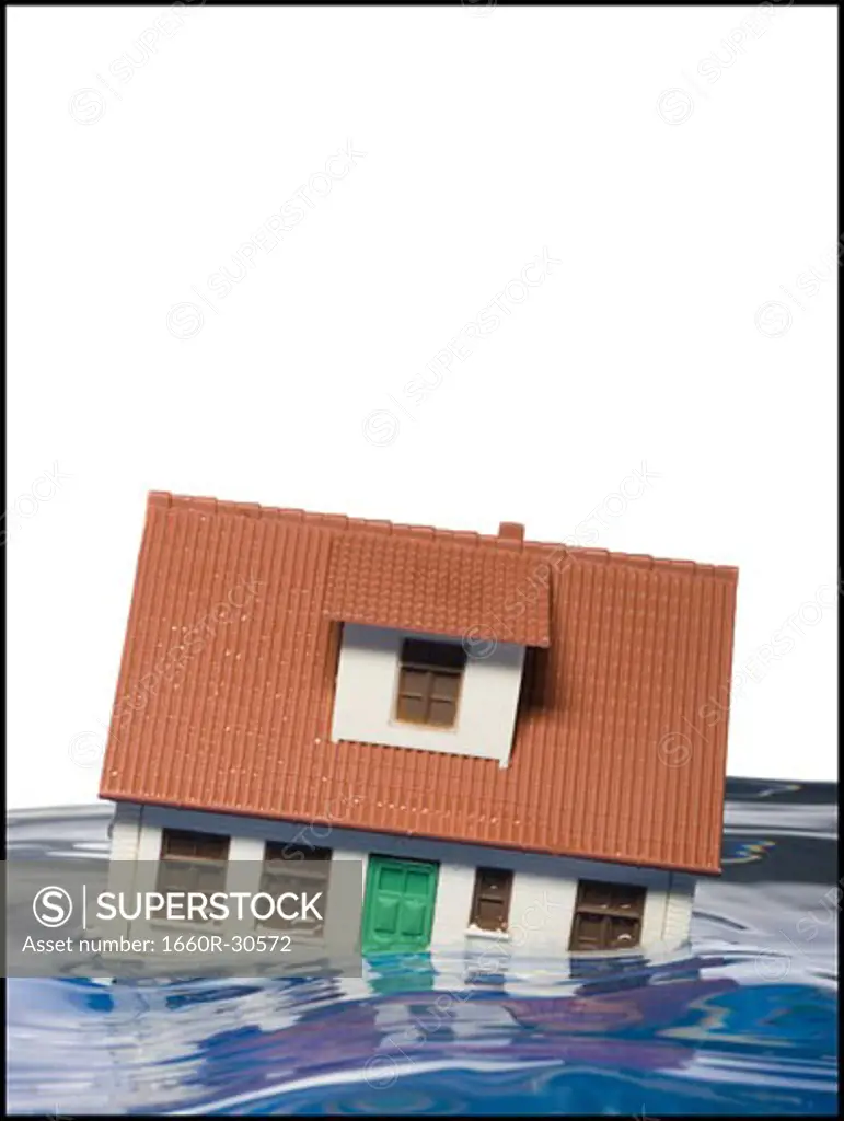Flooded toy house floating in water