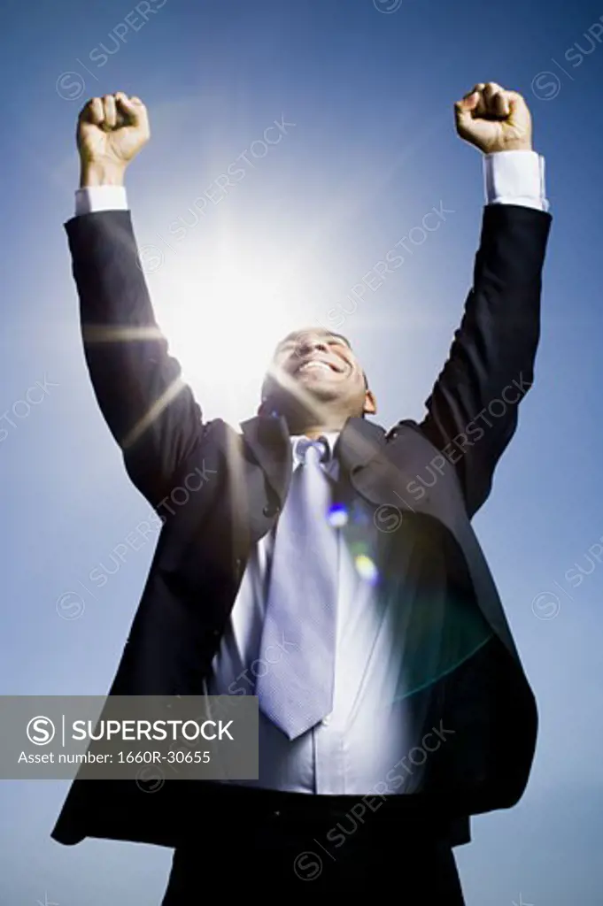 Businessman pumping fists in the air