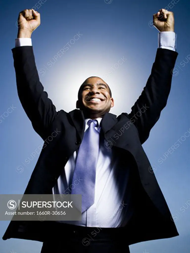 Businessman pumping fists in the air