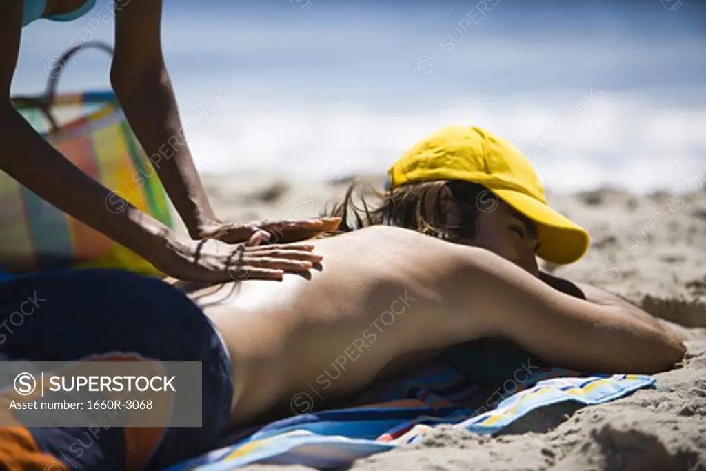 Profile of a young woman giving a young man a massage