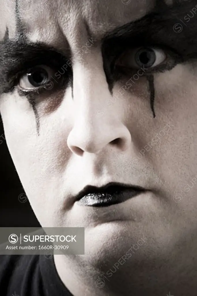 Close-up of man with black and white makeup