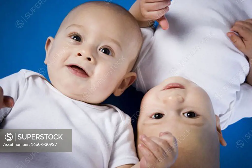 Twin babies looking up