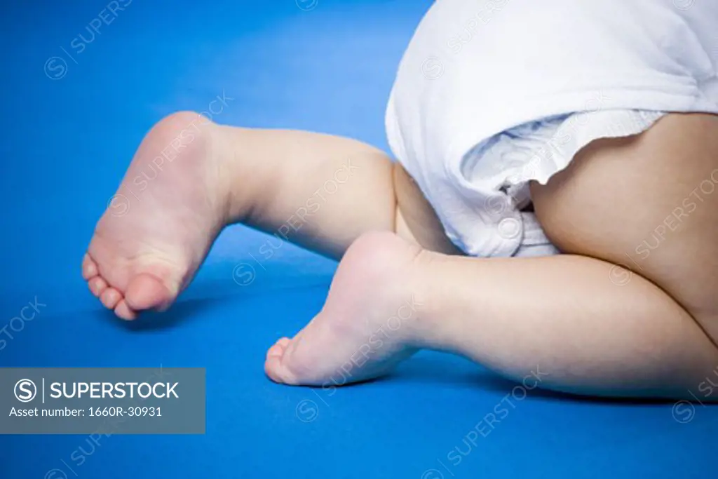 Waist down view of a baby crawling