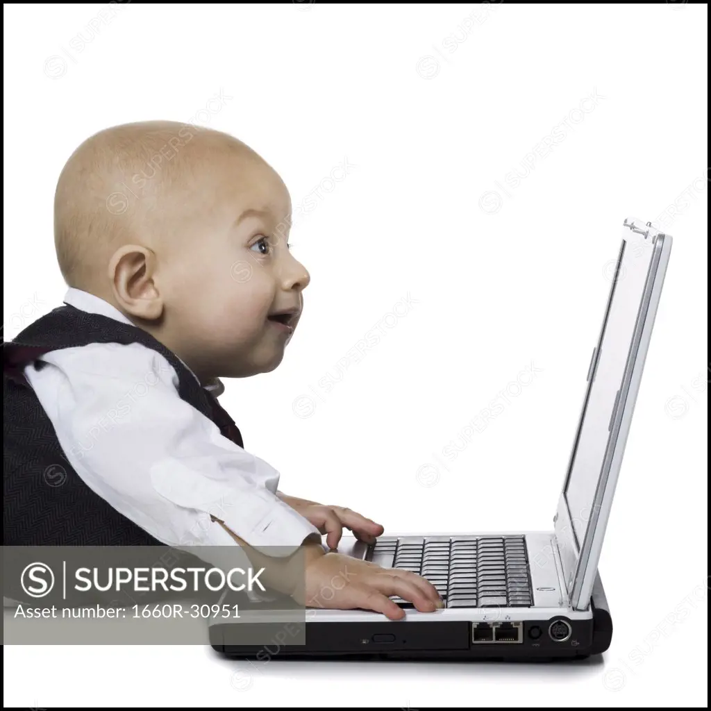Baby boy in suit with laptop