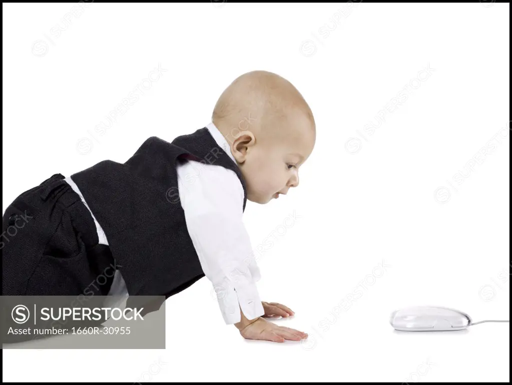 Baby Boy in suit crawling to computer mouse