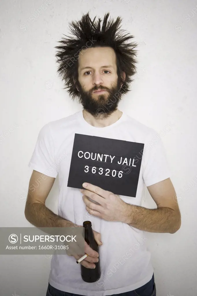 Mug shot of man with cigarette and beer bottle