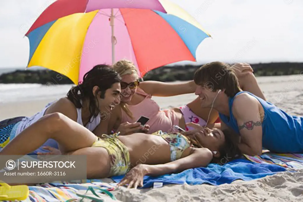 Four young people on the beach