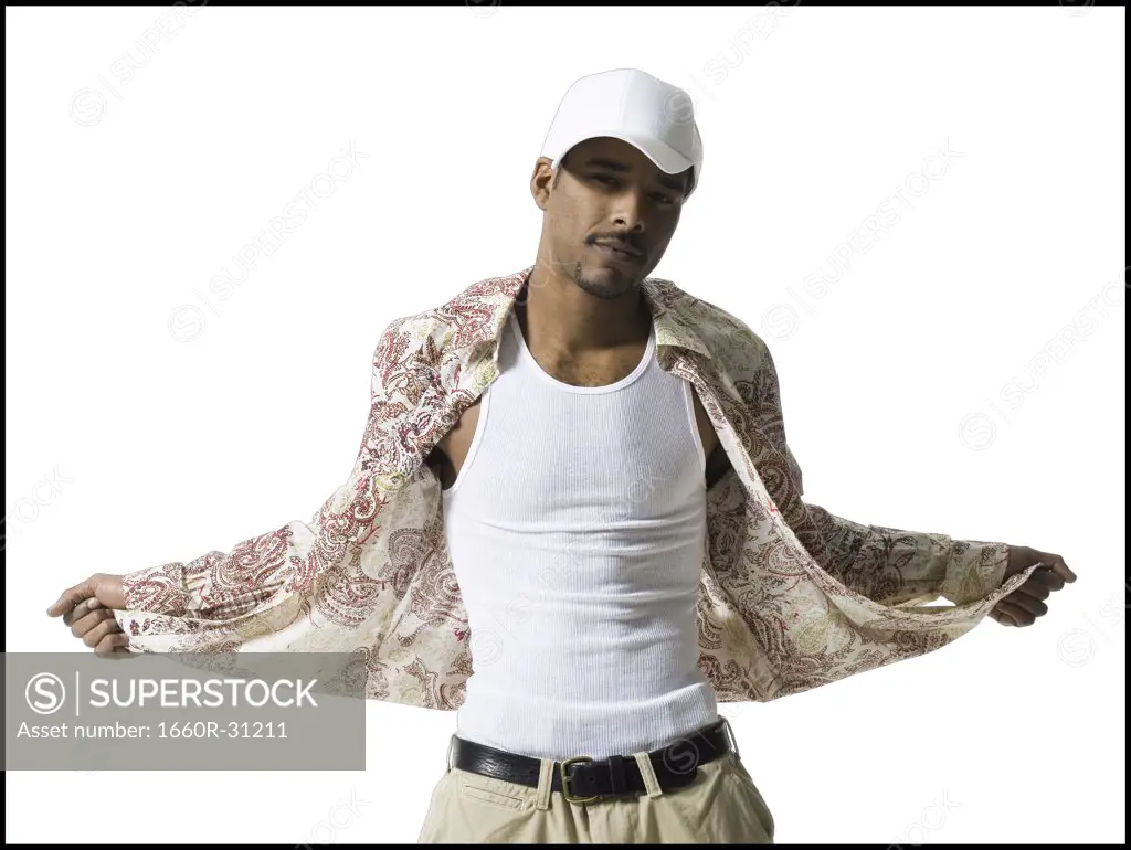 Man in undershirt with cap posing