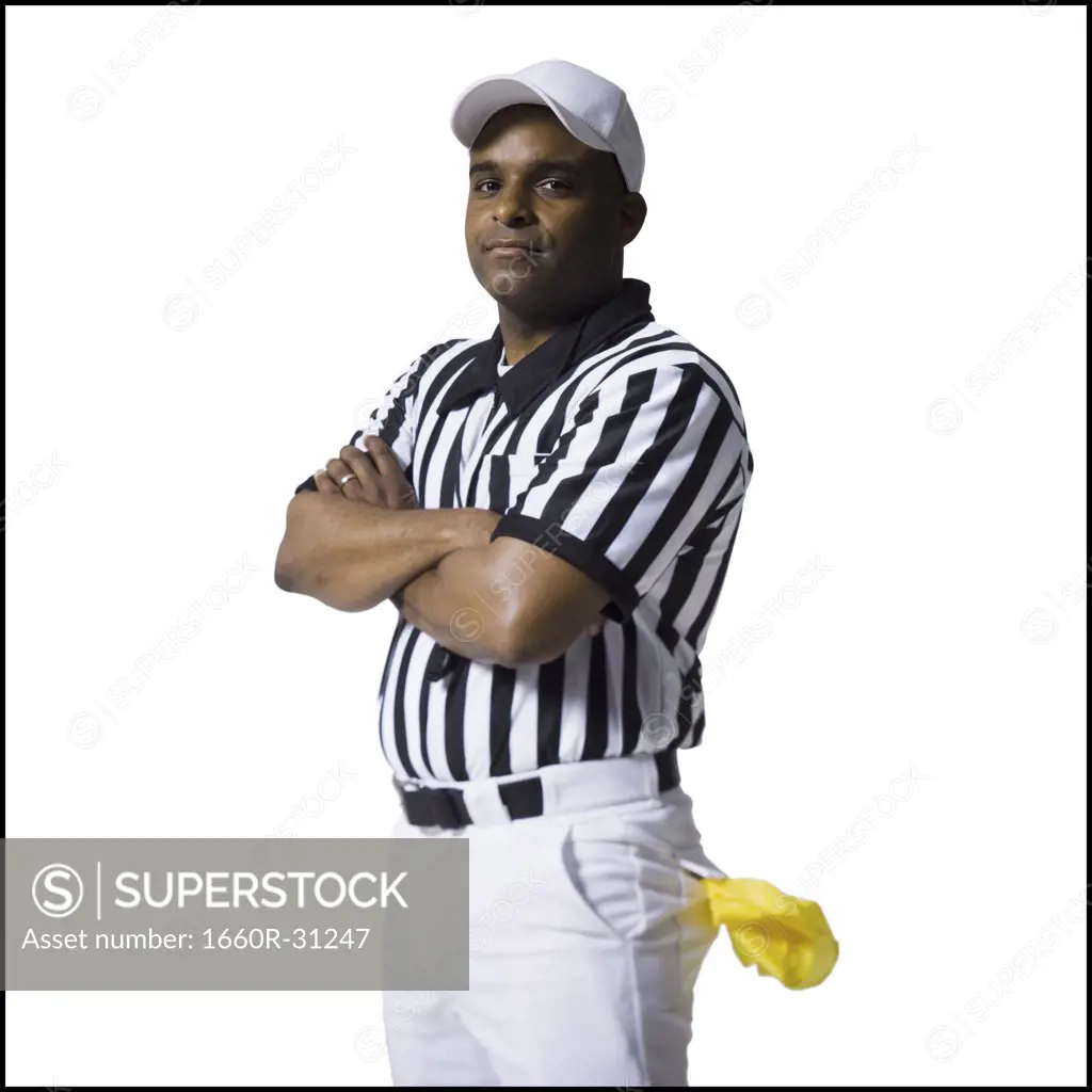 Referee standing with arms crossed