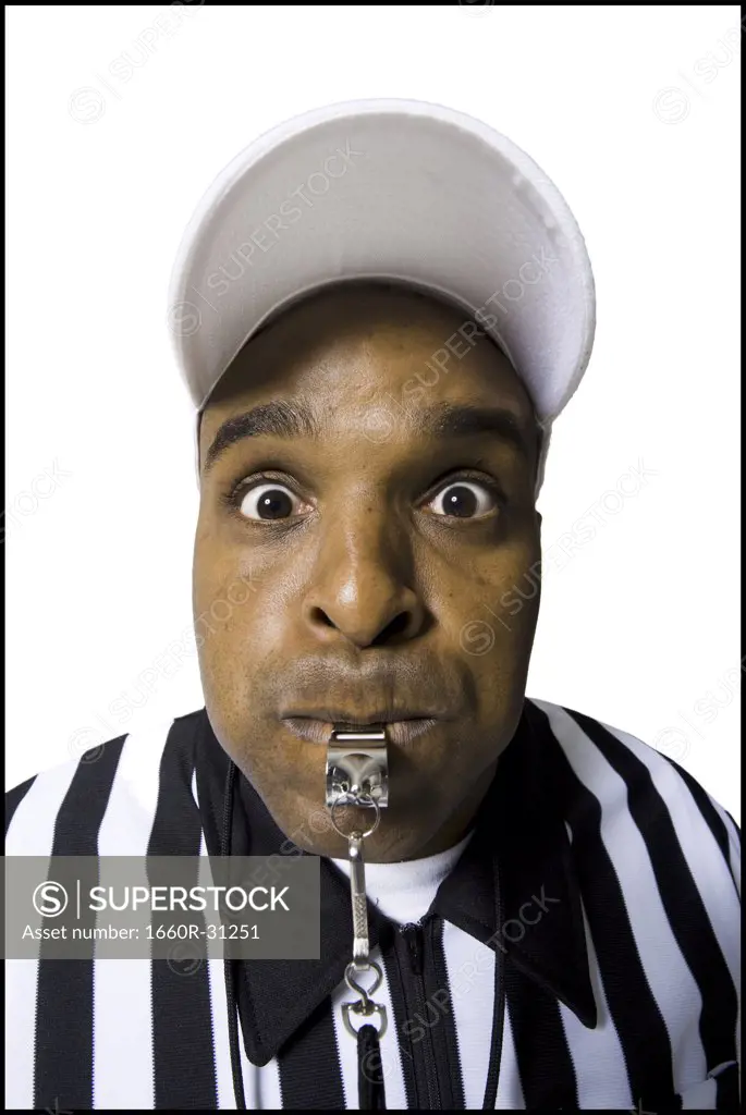 Close-up of referee blowing whistle