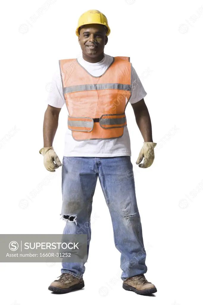Male road worker with crossed arms and hardhat smiling