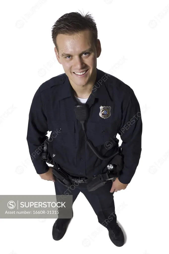 Male police officer standing with arms crossed smiling