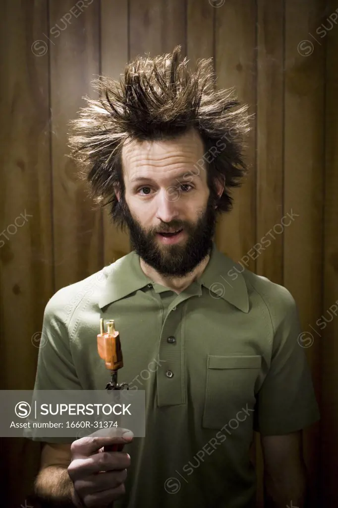 Man with smoking hair and electrical plug