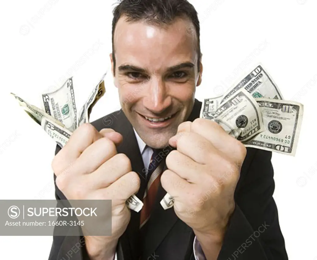 Portrait of a businessman holding dollar bills