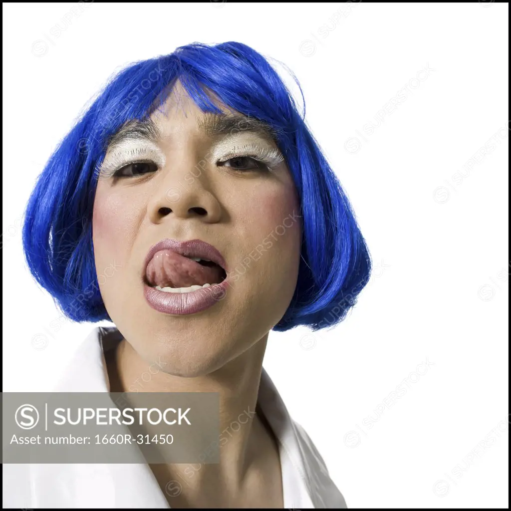 Man with blue wig and makeup yelling