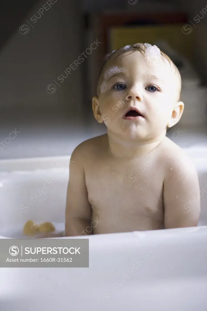 Baby bathing in sink