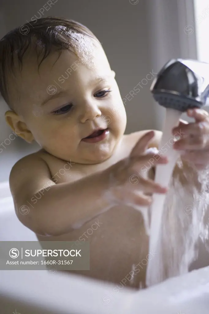 Baby bathing in sink