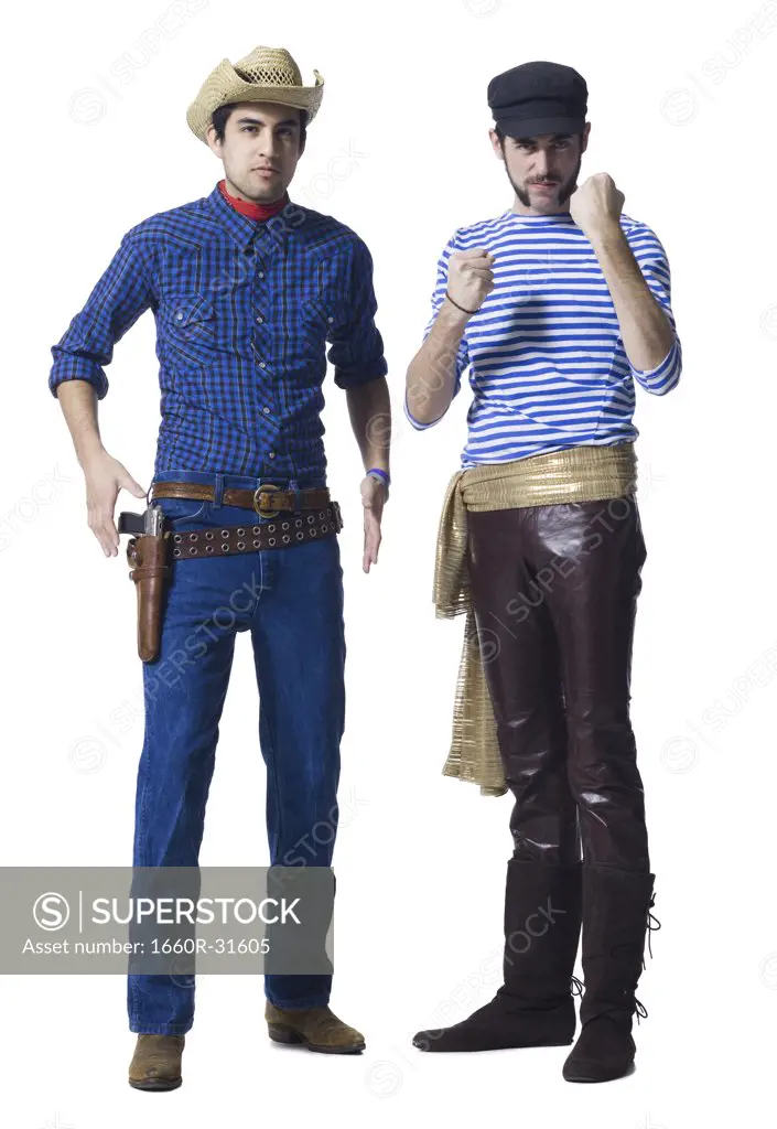 Man in cowboy costume and man with leather pants and waist sash with clenched fists