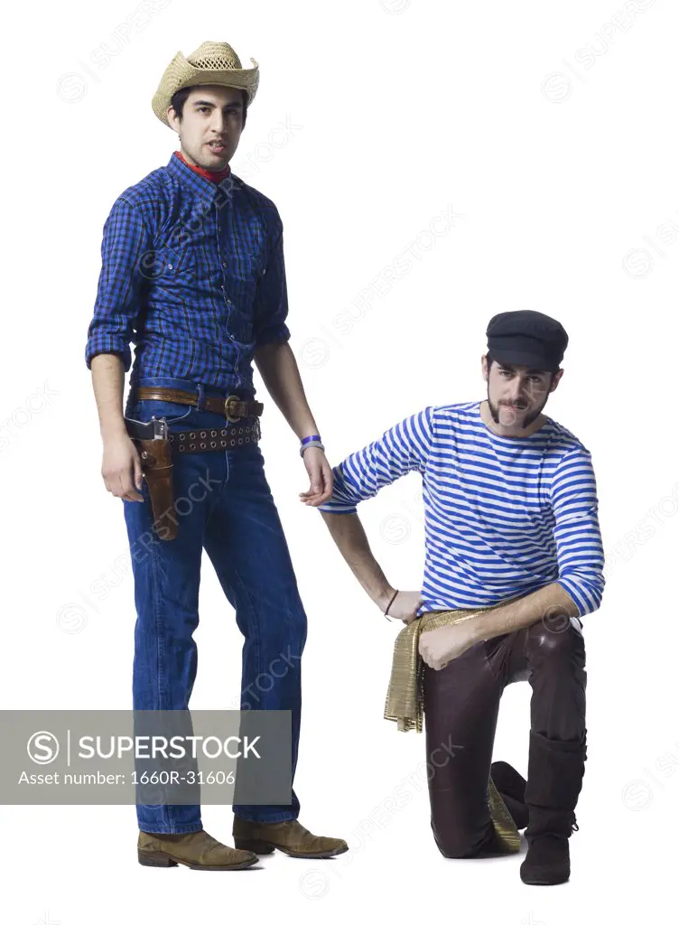 Man in cowboy costume and man with leather pants and waist sash with clenched fists