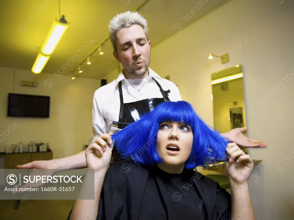 Young woman at hair salon with blue hair
