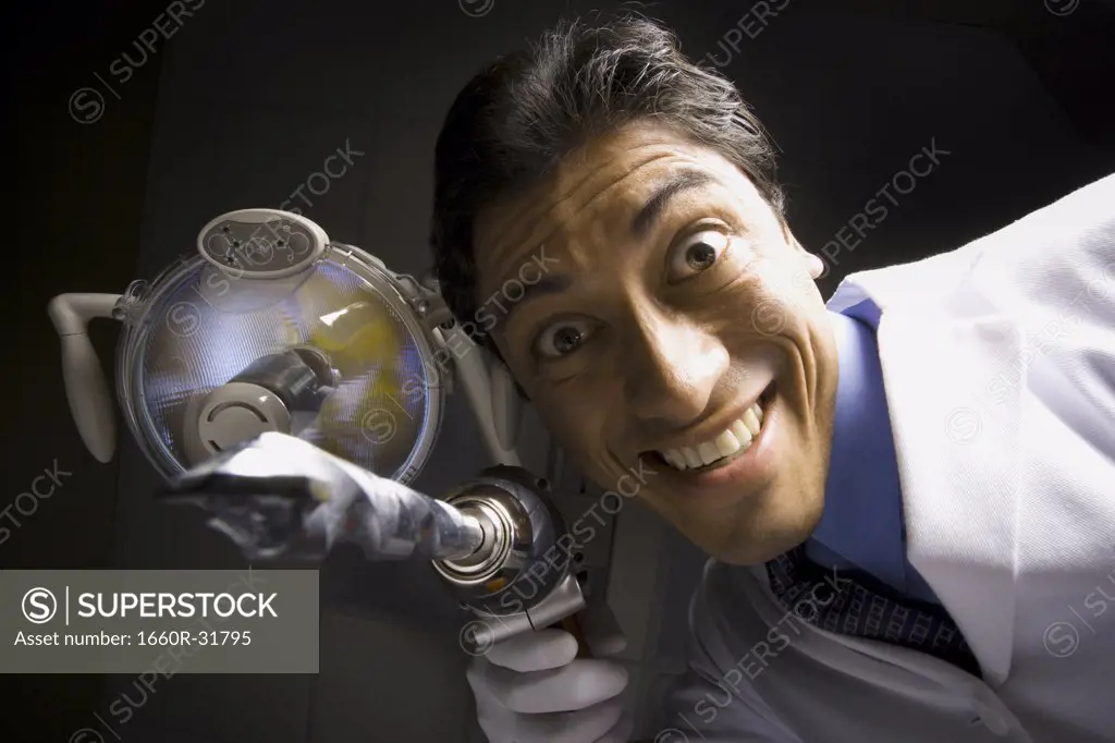 Dentist with drill dramatic angle