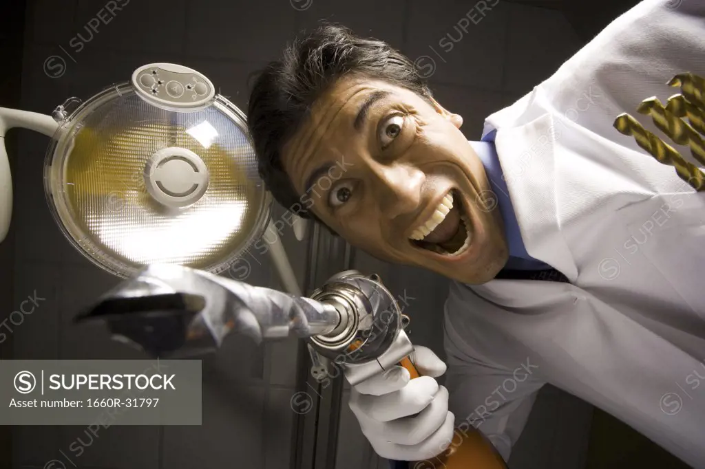 Dentist with drill dramatic angle