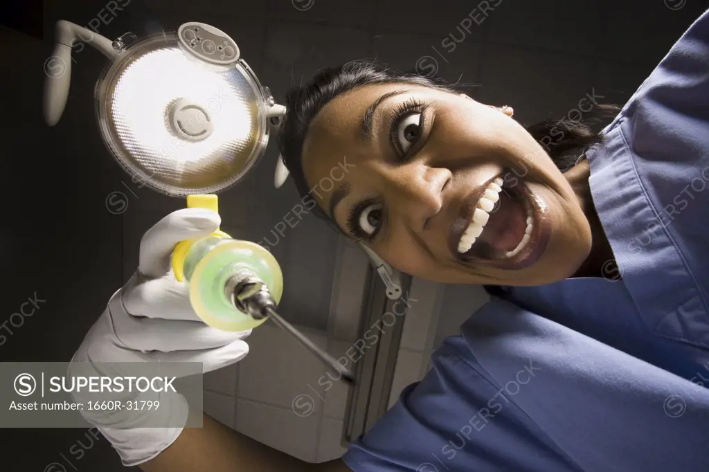Dental hygienist with syringe dramatic angle