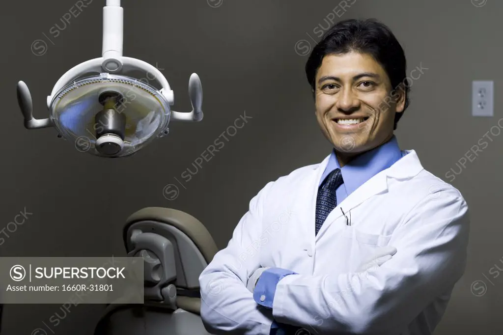 Dentist with arms crossed smiling