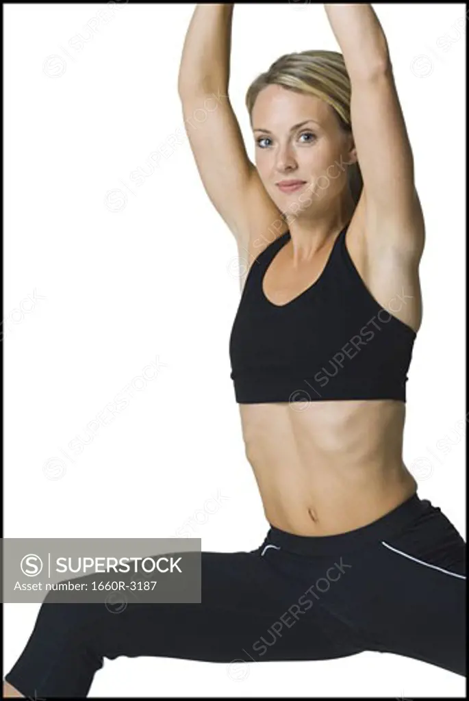 Portrait of a young woman doing stretching exercises
