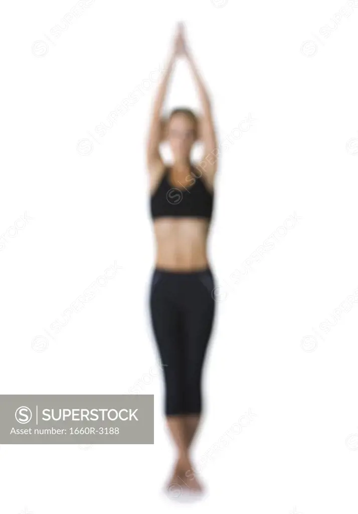 Young woman standing in a yoga posture