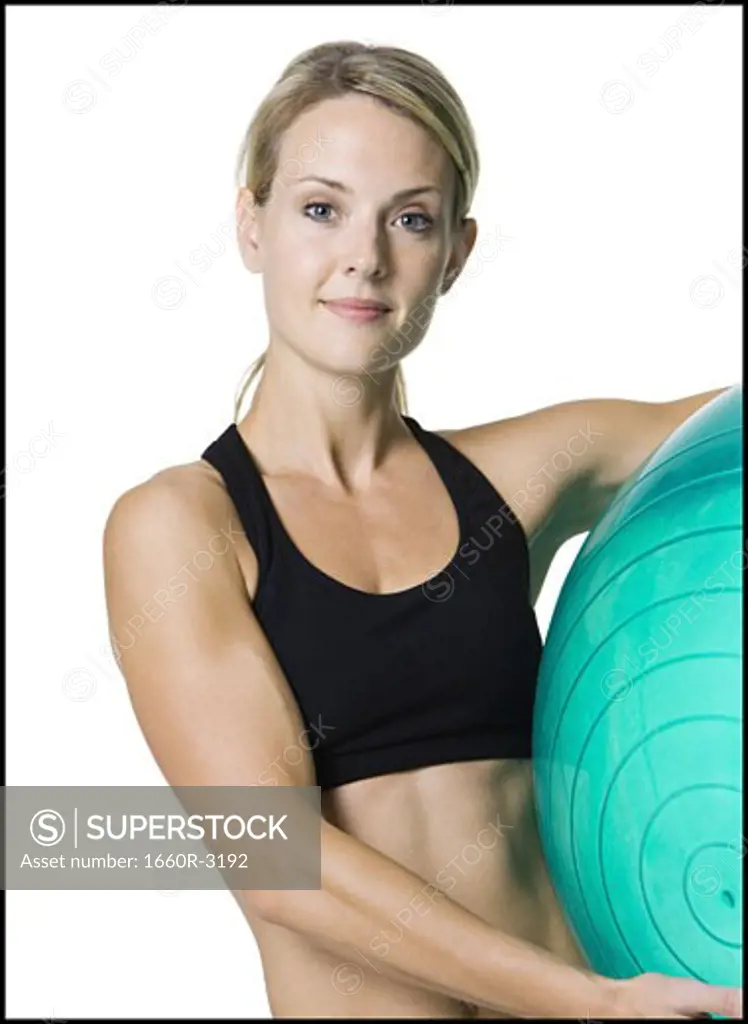 Portrait of a young woman holding an exercise ball