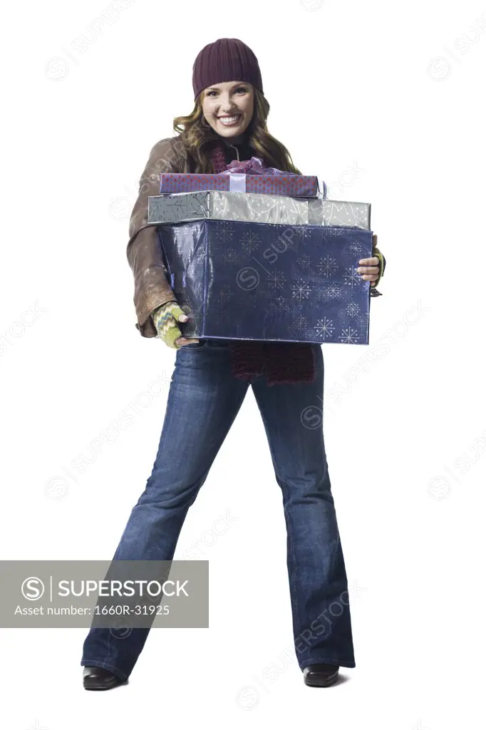 Woman with gifts wearing toque smiling