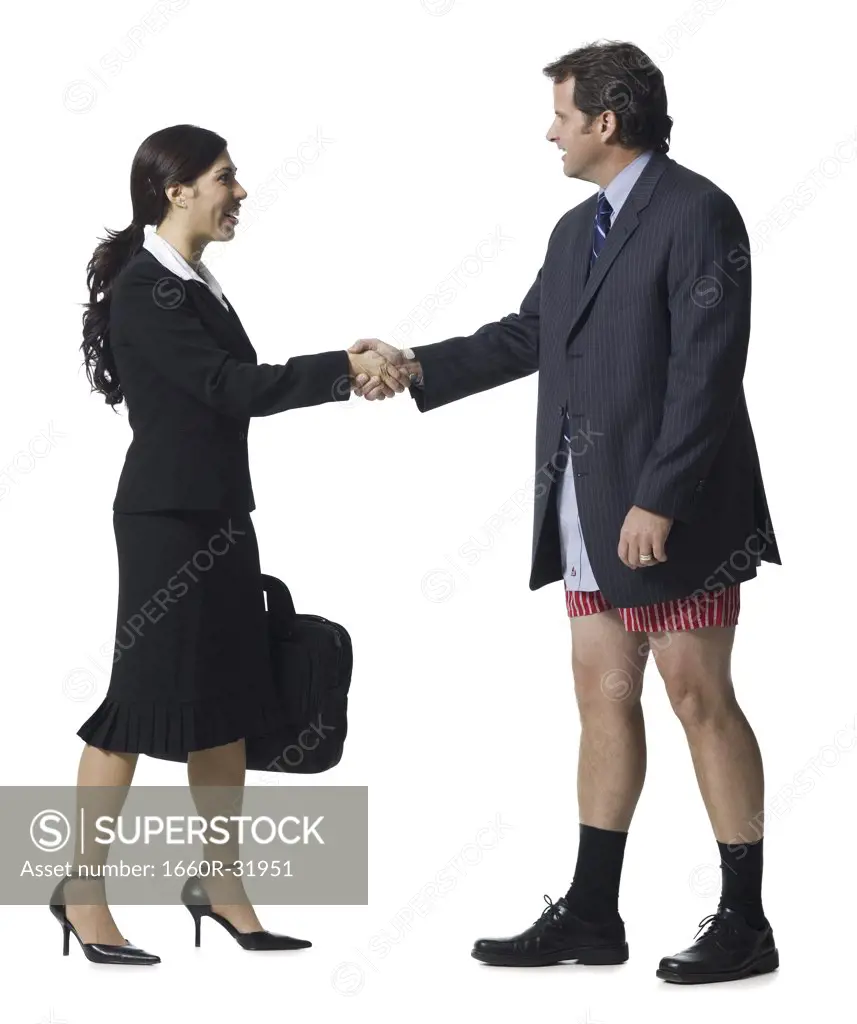 Businesswoman shaking hands with businessman in boxers