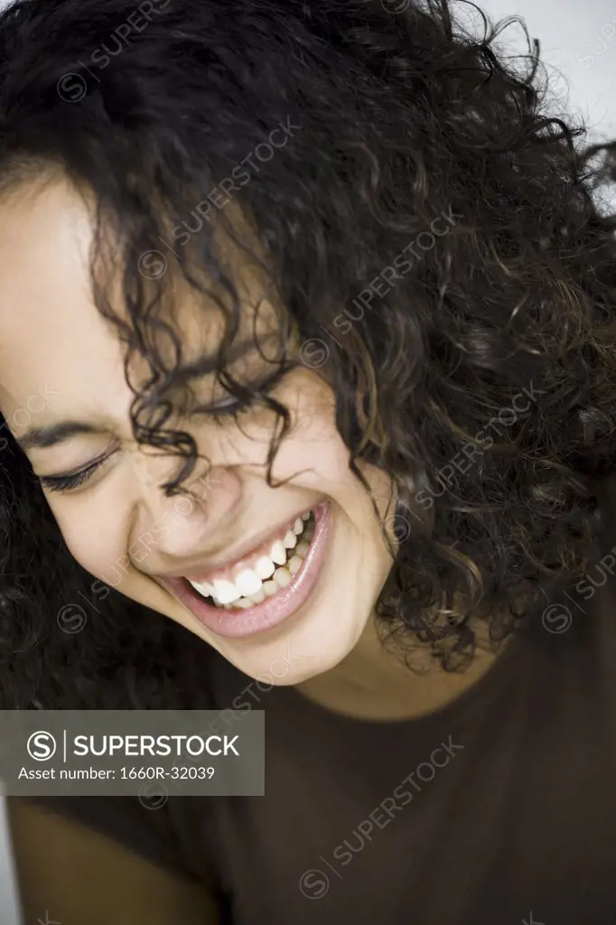Woman smiling with eyes closed