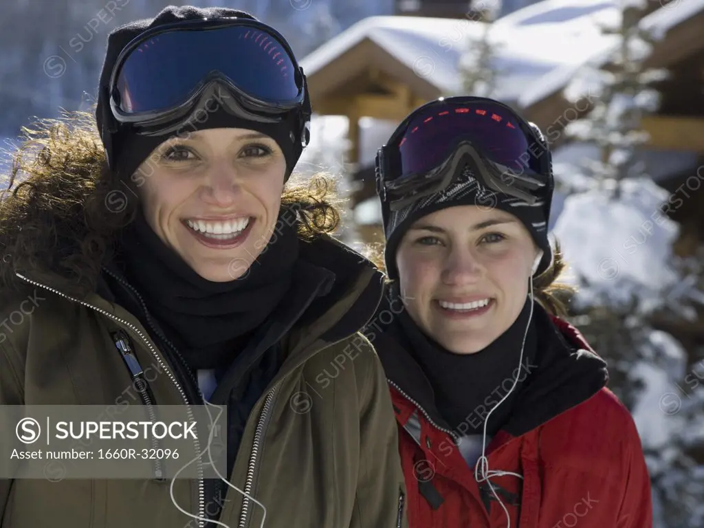 Two women with ski goggles outdoors in winter