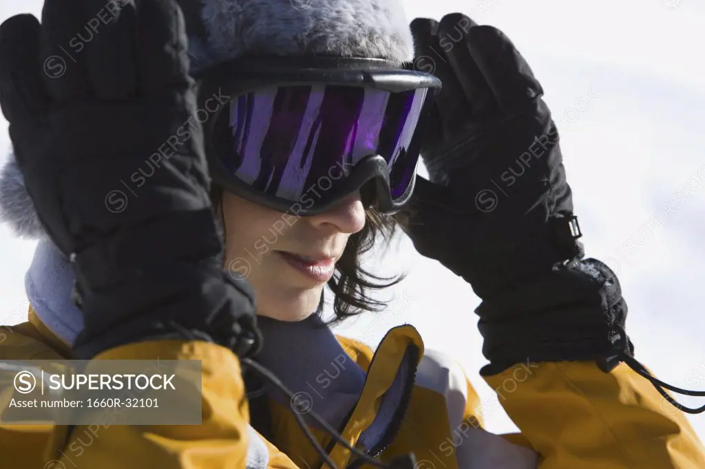 Woman with ski goggles outdoors in winter