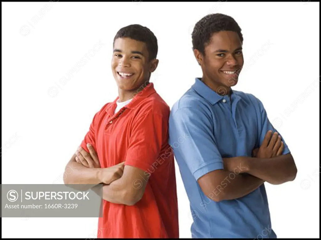 Portrait of a two young men standing back to back