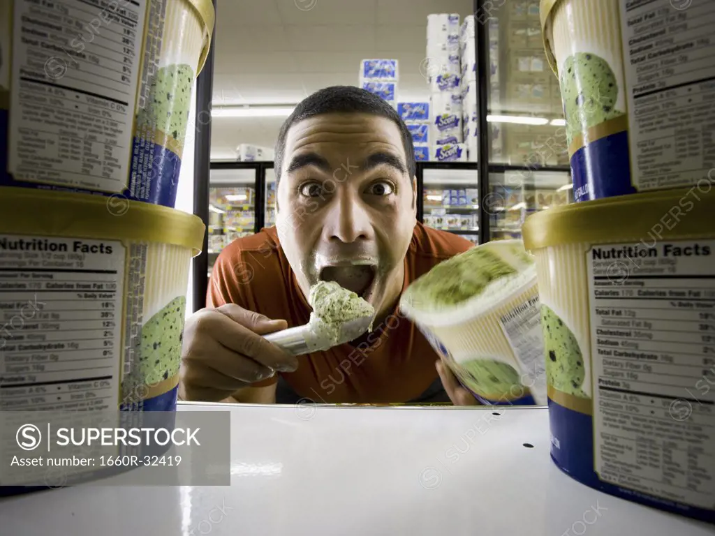 Man eating ice cream at grocery store